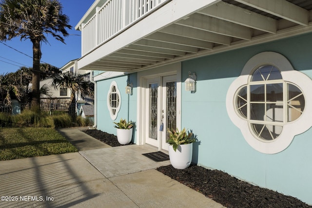 view of exterior entry with a balcony