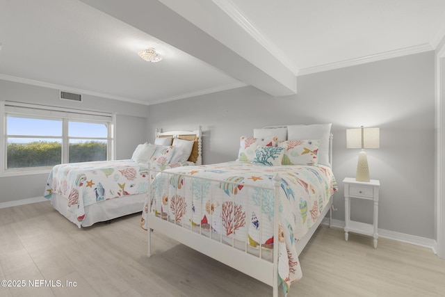 bedroom featuring ornamental molding and light hardwood / wood-style flooring