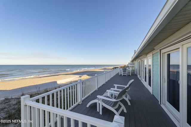 deck featuring a beach view and a water view