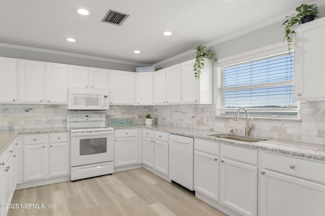 kitchen with sink, light wood-type flooring, white cabinets, light stone countertops, and white appliances