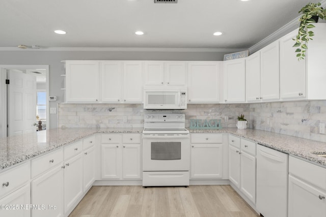 kitchen with light stone counters, white appliances, light hardwood / wood-style floors, decorative backsplash, and white cabinets