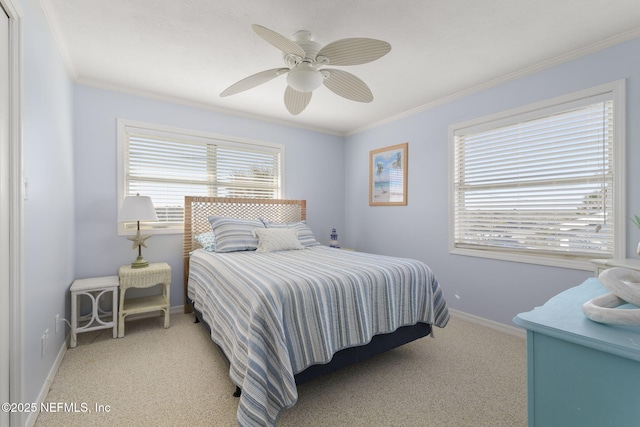 carpeted bedroom with ceiling fan and ornamental molding