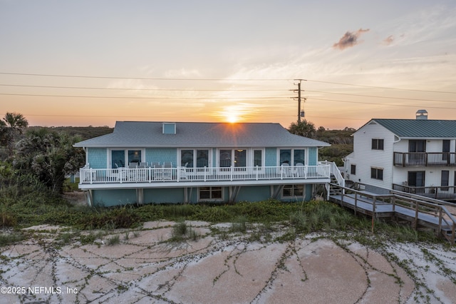 view of back house at dusk