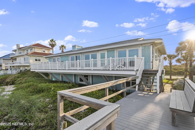 back of house featuring a wooden deck