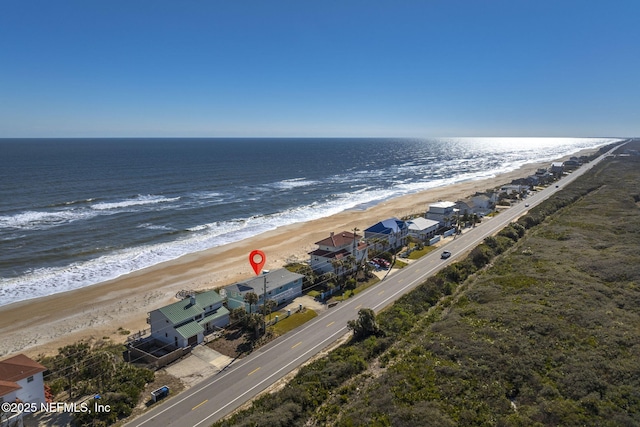 birds eye view of property with a water view and a view of the beach