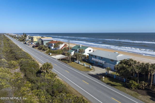 drone / aerial view featuring a water view and a beach view