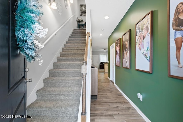 stairs featuring hardwood / wood-style floors