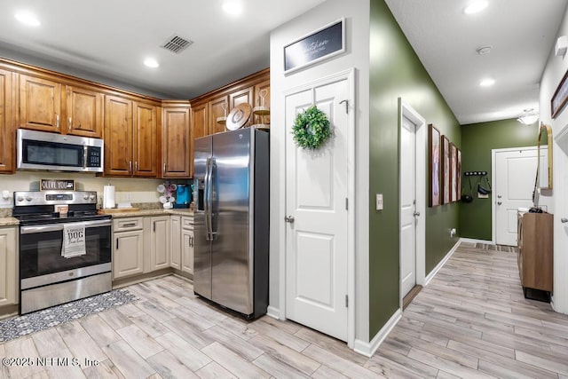 kitchen featuring light stone countertops and appliances with stainless steel finishes