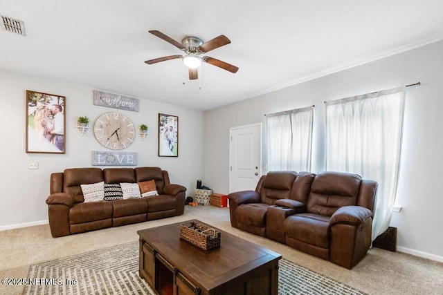 carpeted living room with ceiling fan