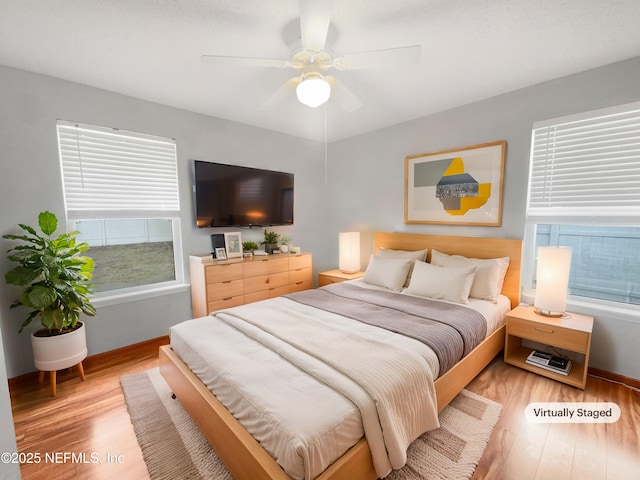 bedroom with light wood-type flooring and ceiling fan