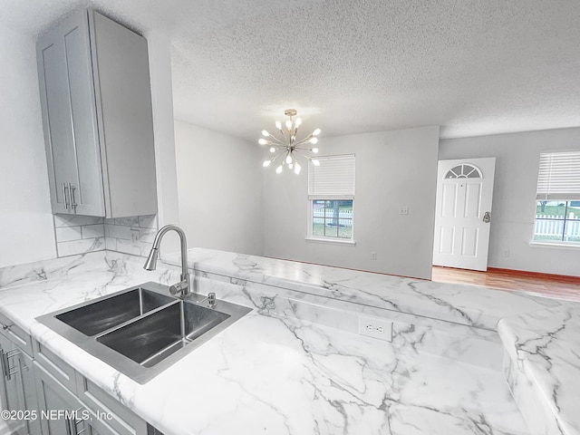 kitchen with sink, decorative backsplash, and gray cabinetry