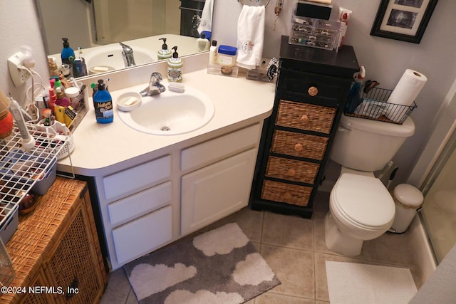 bathroom featuring toilet, tile patterned flooring, and vanity