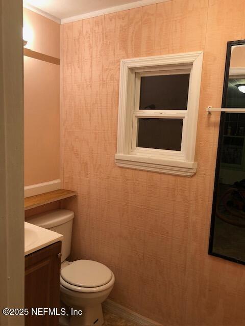 bathroom featuring ornamental molding, toilet, and vanity