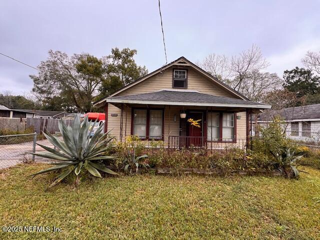 bungalow-style home with a front yard and a porch