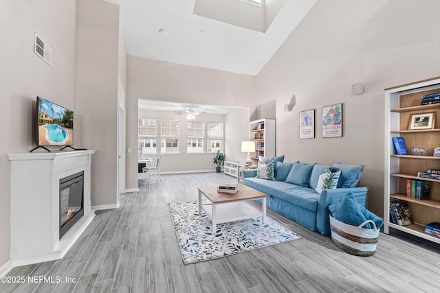 living room with high vaulted ceiling and ceiling fan