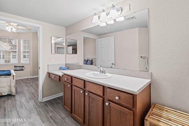 bathroom with vanity, a textured ceiling, and ceiling fan