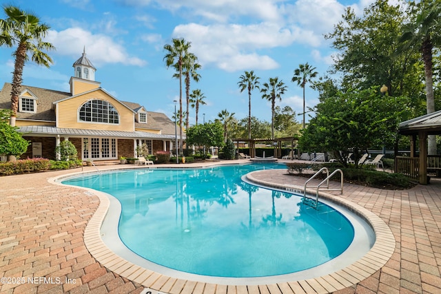 view of swimming pool with a pergola and a patio area