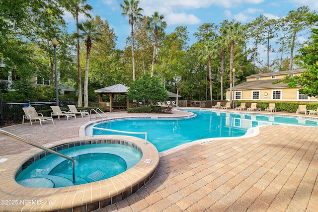 view of swimming pool featuring a gazebo, a community hot tub, and a patio area