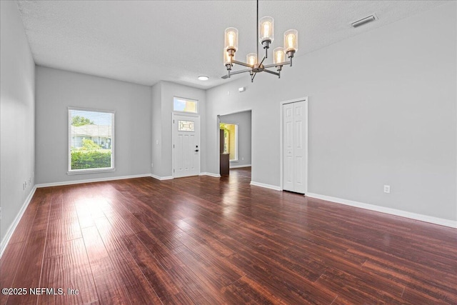 1560 Timber Trace Dr, Saint Augustine, FL 32092 - unfurnished living room with a chandelier, wood finished floors, and a textured ceiling