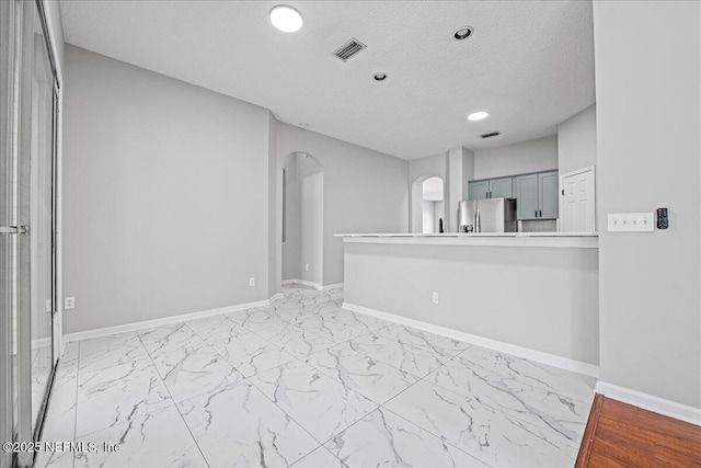 1560 Timber Trace Dr, Saint Augustine, FL 32092 - unfurnished room with arched walkways, light marble finish floors, recessed lighting, and a textured ceiling