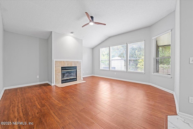 1560 Timber Trace Dr, Saint Augustine, FL 32092 - unfurnished living room with a ceiling fan, healthy amount of natural light, a textured ceiling, wood finished floors, and a fireplace