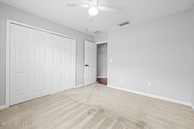 1560 Timber Trace Dr, Saint Augustine, FL 32092 - unfurnished bedroom featuring carpet flooring, a textured ceiling, a closet, and ceiling fan