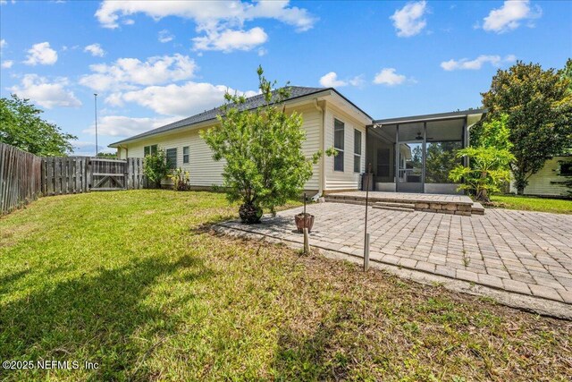 1560 Timber Trace Dr, Saint Augustine, FL 32092 - back of house with a sunroom, a patio, a gate, and a fenced backyard