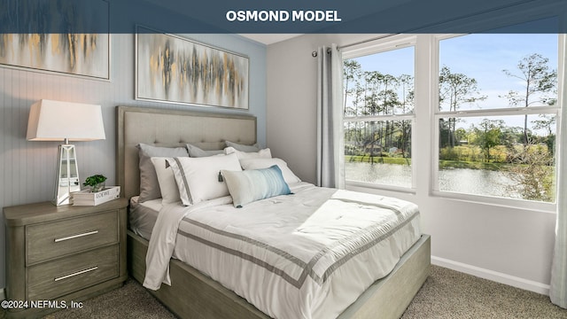 carpeted bedroom with multiple windows and a water view