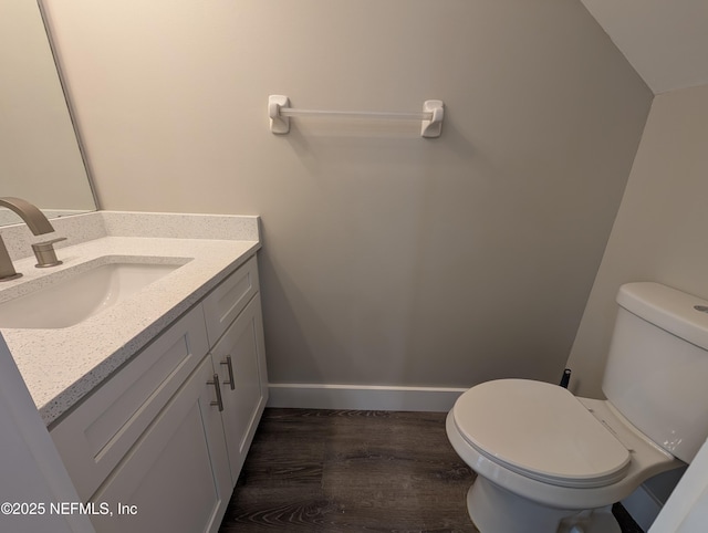 bathroom featuring vanity, toilet, and hardwood / wood-style floors