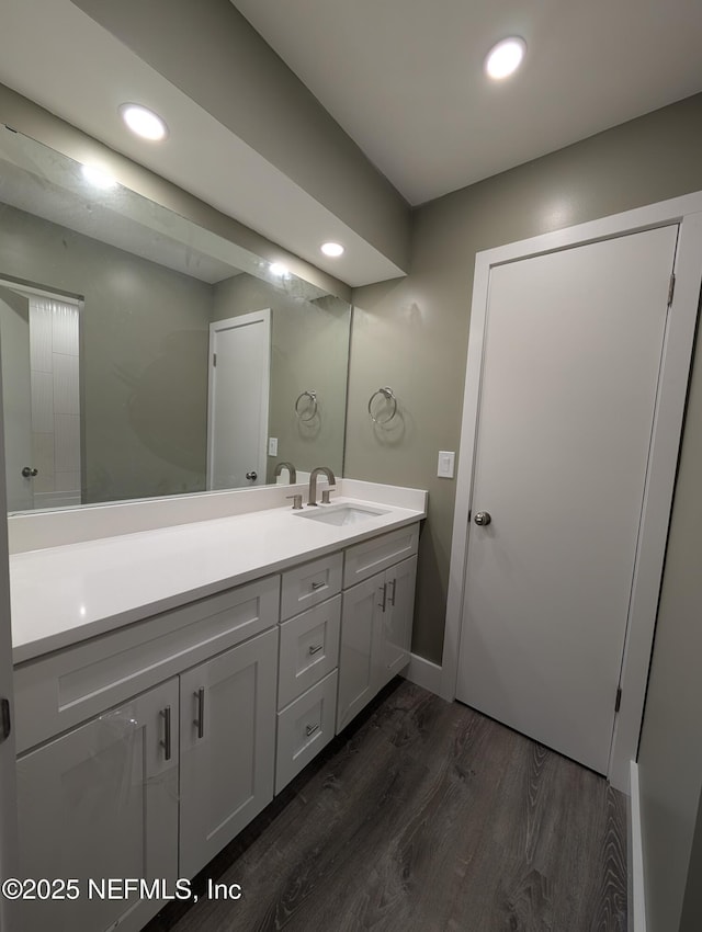 bathroom with vanity and hardwood / wood-style floors