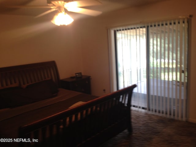 carpeted bedroom featuring ceiling fan and multiple windows