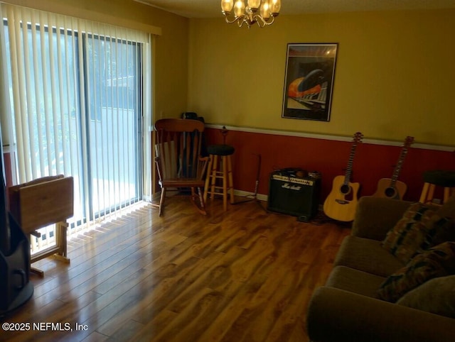 living area featuring wood-type flooring and a chandelier