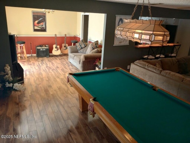 recreation room featuring hardwood / wood-style flooring, a textured ceiling, and pool table