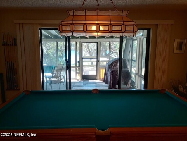 rec room featuring pool table and a textured ceiling