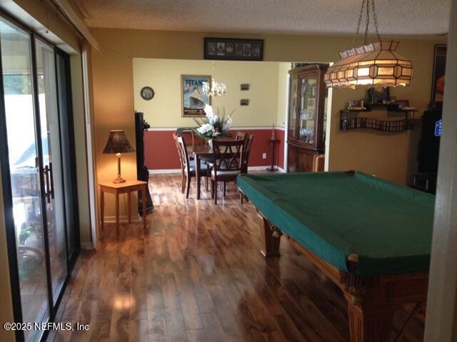 playroom featuring hardwood / wood-style floors, pool table, and a textured ceiling