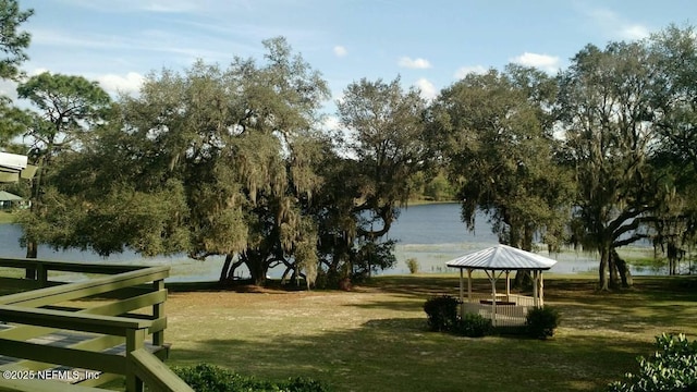 surrounding community with a lawn, a gazebo, and a water view