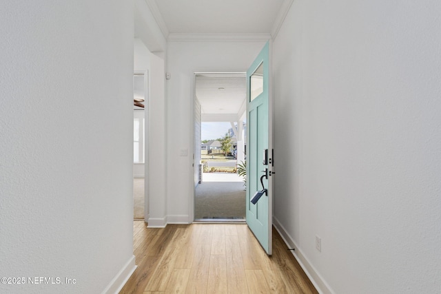 entryway with crown molding and light hardwood / wood-style flooring