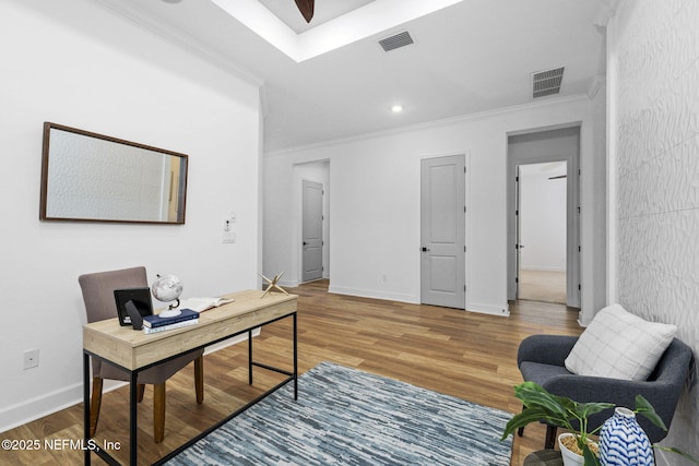 office area with wood-type flooring and ornamental molding