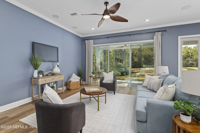 living room with crown molding and light hardwood / wood-style flooring