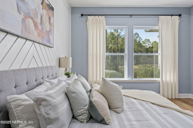 bedroom featuring multiple windows and hardwood / wood-style floors