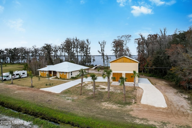 view of community featuring a water view and a yard