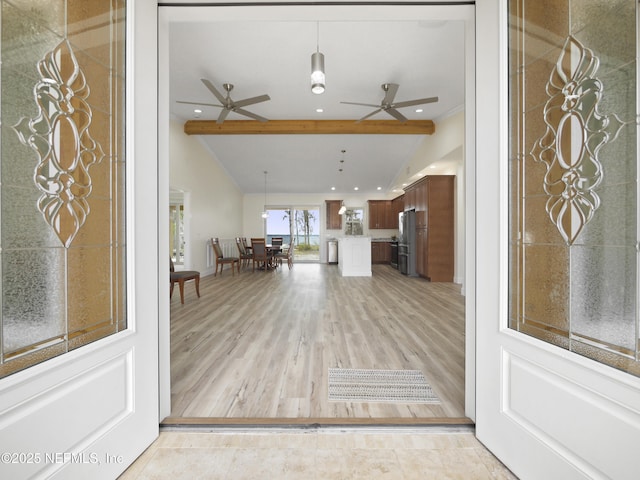 entrance foyer with ceiling fan, lofted ceiling with beams, and light hardwood / wood-style flooring