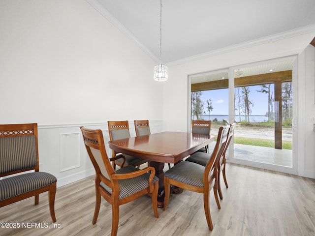 dining space featuring ornamental molding, a chandelier, and light wood-type flooring