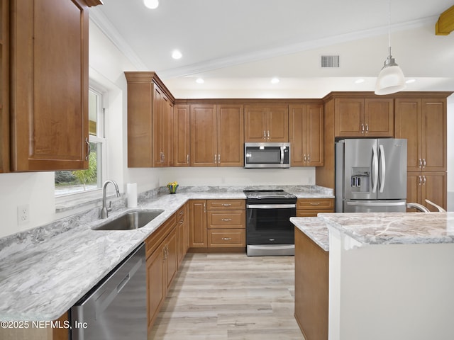 kitchen with pendant lighting, sink, ornamental molding, light stone counters, and stainless steel appliances