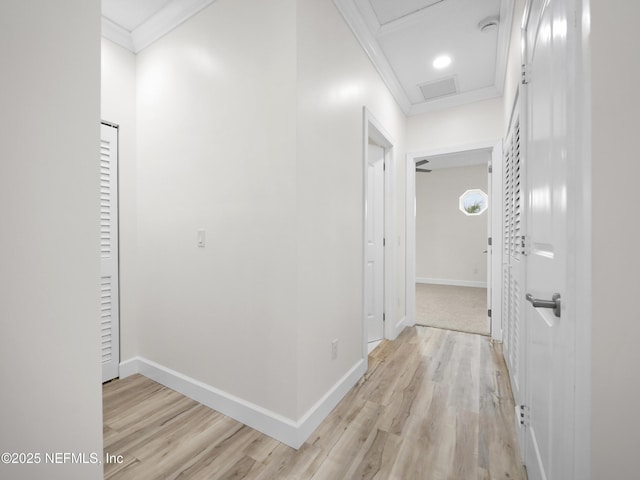 corridor featuring ornamental molding and light hardwood / wood-style flooring