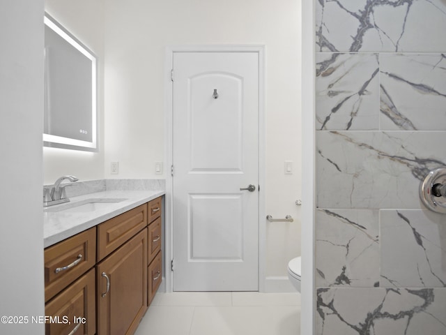 bathroom with tile patterned flooring, vanity, and toilet