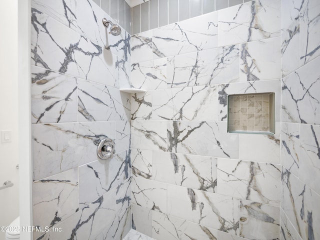 bathroom with tiled shower