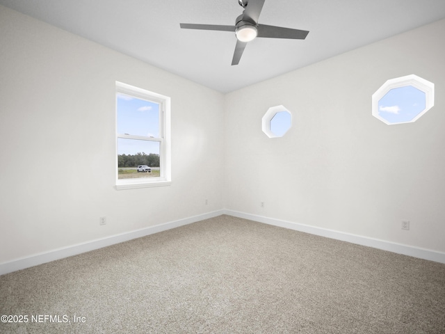 empty room featuring ceiling fan and carpet floors