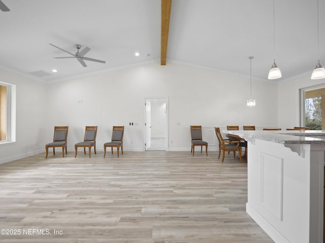 kitchen with decorative light fixtures, vaulted ceiling with beams, ornamental molding, ceiling fan, and light hardwood / wood-style flooring