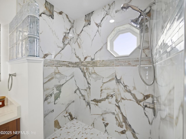 bathroom featuring vanity and tiled shower